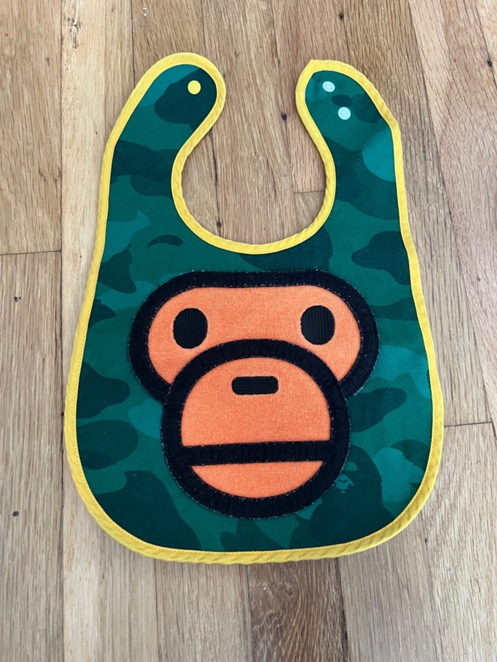Green Camo Baby Bib with Orange Ape Face and Yellow Trim